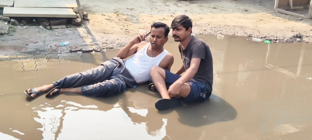 राजातालाब में अनोखा विरोध: सीवर के गंदे पानी के बीच सड़क पर लेटकर युवक ने जताया आक्रोश